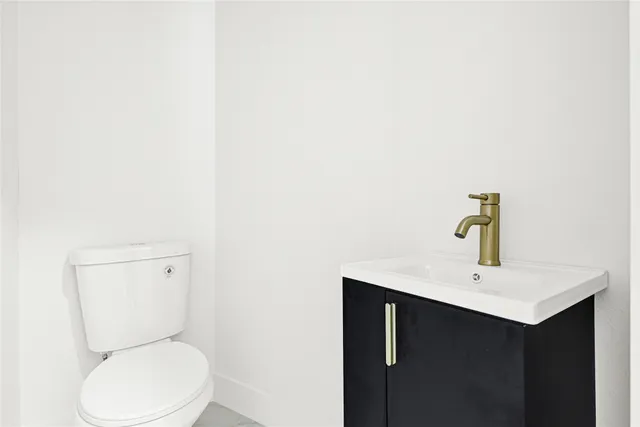 a view of a hallway with wooden floor and closet area