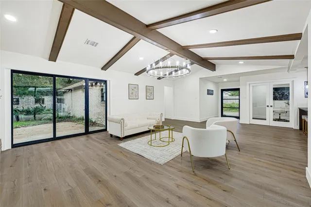 a view of a livingroom with furniture wooden floor and windows
