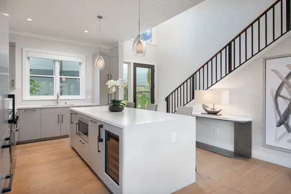 a kitchen with sink a stove and cabinets