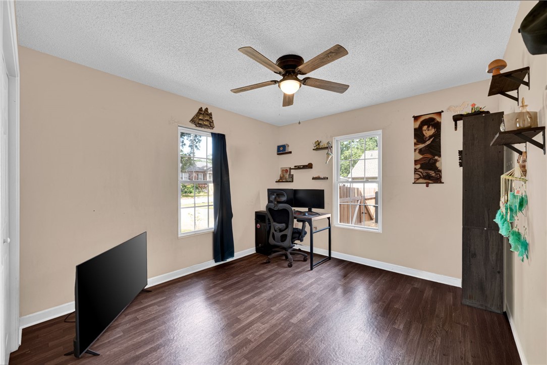 1020 Elizabeth Street Anderson, SC 29624 - Photo 13 of 22 A versatile room with ample natural light features rich hardwood flooring and a functional ceiling fan.