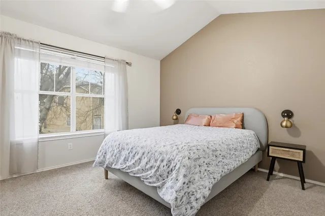 a bedroom with a bed and window