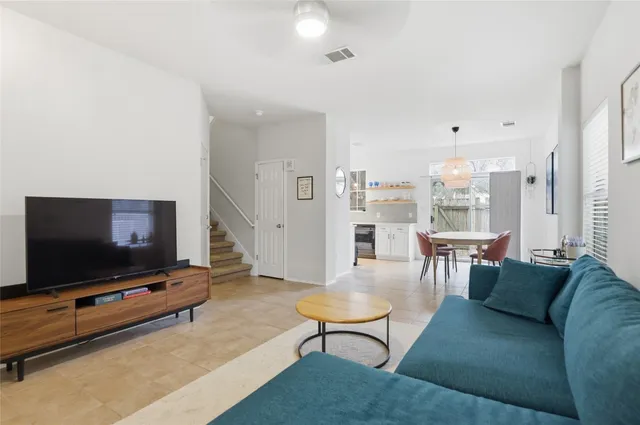 a living room with furniture and a flat screen tv