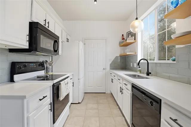 a view of a kitchen with sink washer and dryer