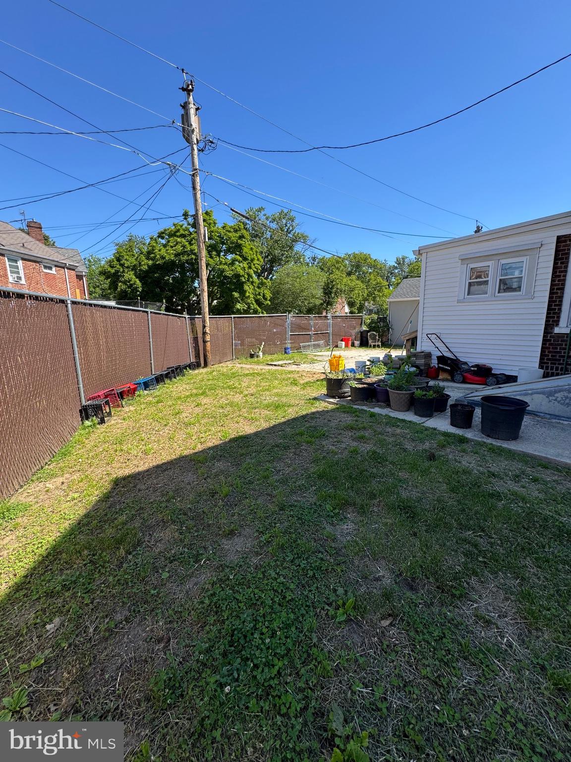 1515 Collings Road Camden, NJ 08104 - Photo 22 of 23 a view of a backyard with table and chairs and wooden fence