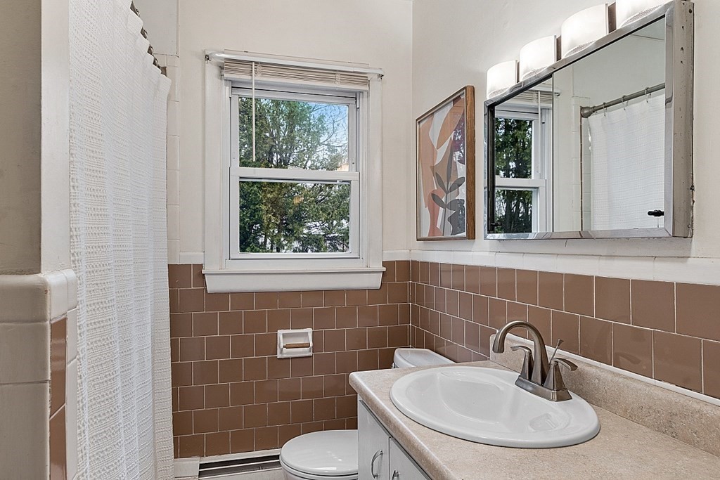 1016 George Hill Road Lancaster, MA 01523 - Photo 17 of 41 a bathroom with a sink a toilet and a mirror
