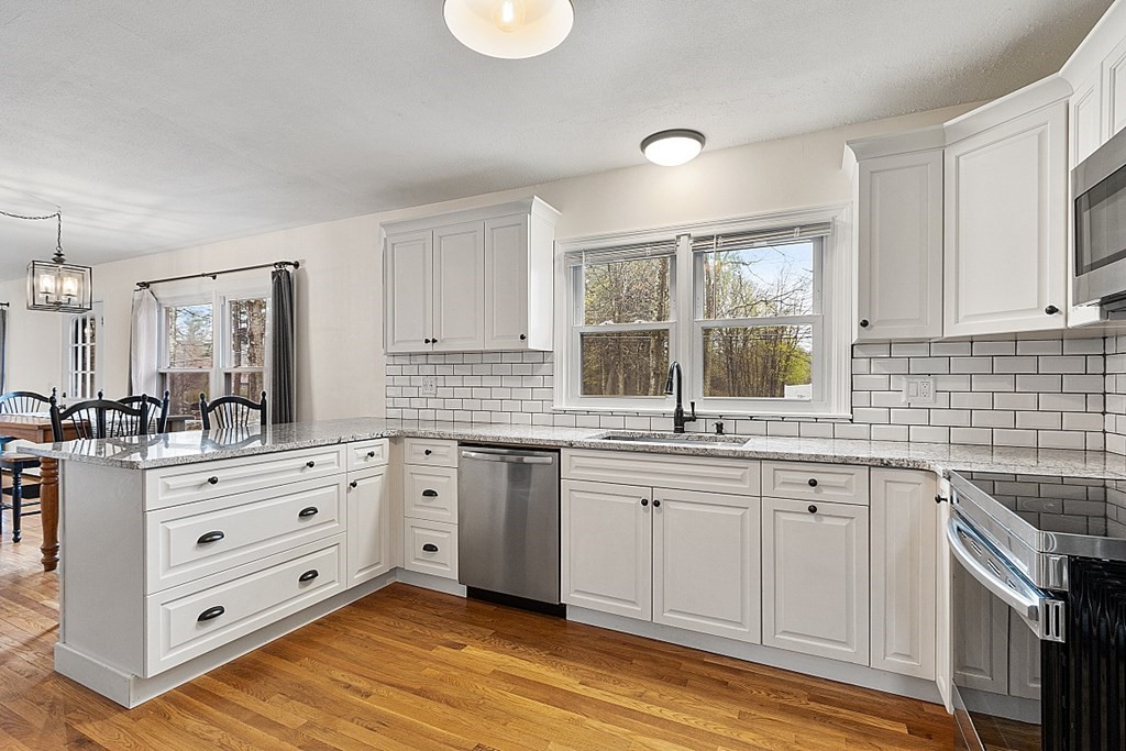 1016 George Hill Road Lancaster, MA 01523 - Photo 3 of 41 a kitchen with granite countertop a sink cabinets stainless steel appliances and a window