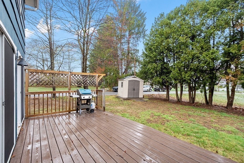 1016 George Hill Road Lancaster, MA 01523 - Photo 34 of 41 a view of backyard with a deck and wooden floor