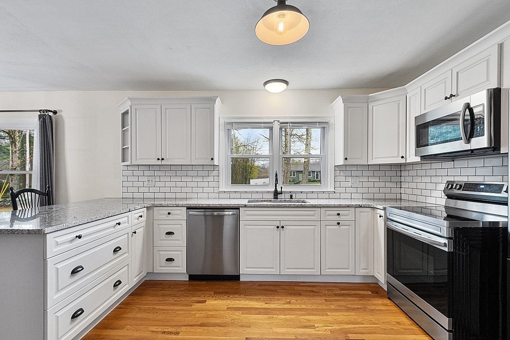 1016 George Hill Road Lancaster, MA 01523 - Photo 4 of 41 a kitchen with stainless steel appliances granite countertop a stove and a sink