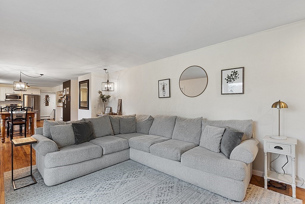 1016 George Hill Road Lancaster, MA 01523 - Photo 9 of 41 a living room with furniture white walls and a dining table