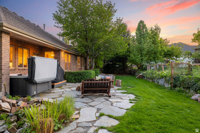 6208 West Bull River Road Highland, UT 84003 - Photo 69 of 90 Expansive backyard featuring a natural stone patio, mature trees, a manicured lawn, and brick exterior
