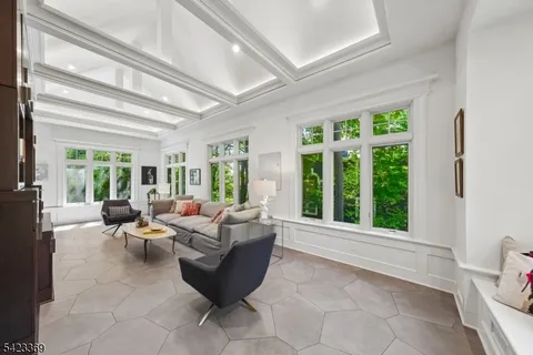 a living room with furniture and large windows