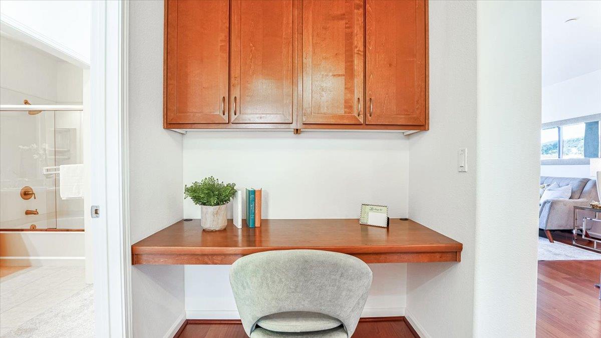 1388 Broadway, Unit 407 Millbrae, CA 94030 - Photo 11 of 28 a kitchen with stainless steel appliances granite countertop a sink and a white cabinets