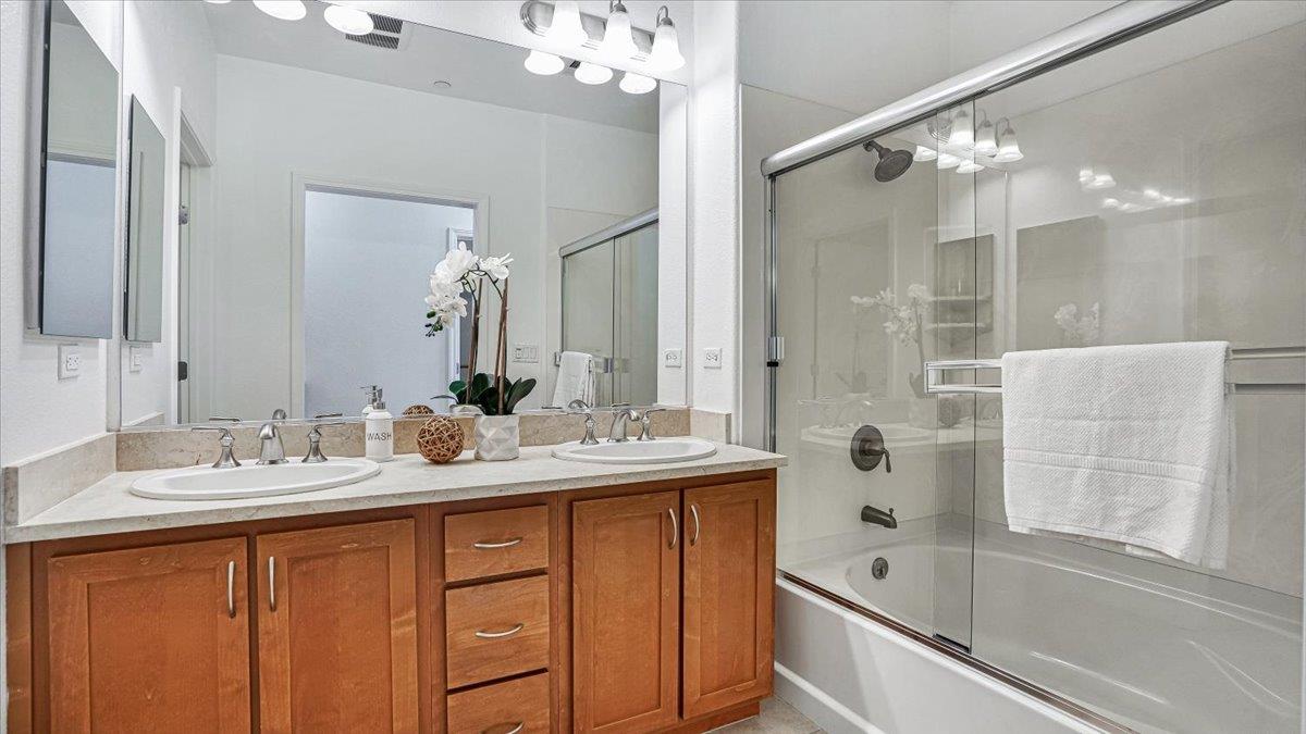 1388 Broadway, Unit 407 Millbrae, CA 94030 - Photo 12 of 28 a bathroom with a double vanity sink mirror double and bathtub