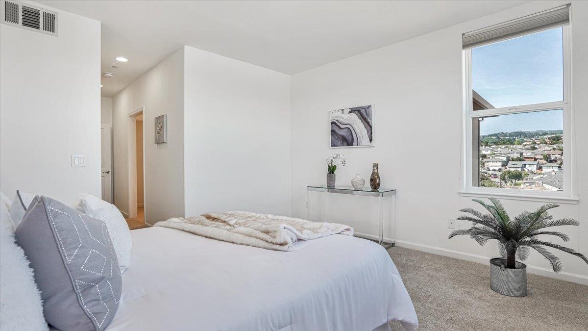 1388 Broadway, Unit 407 Millbrae, CA 94030 - Photo 15 of 28 a bedroom with a bed and a couch