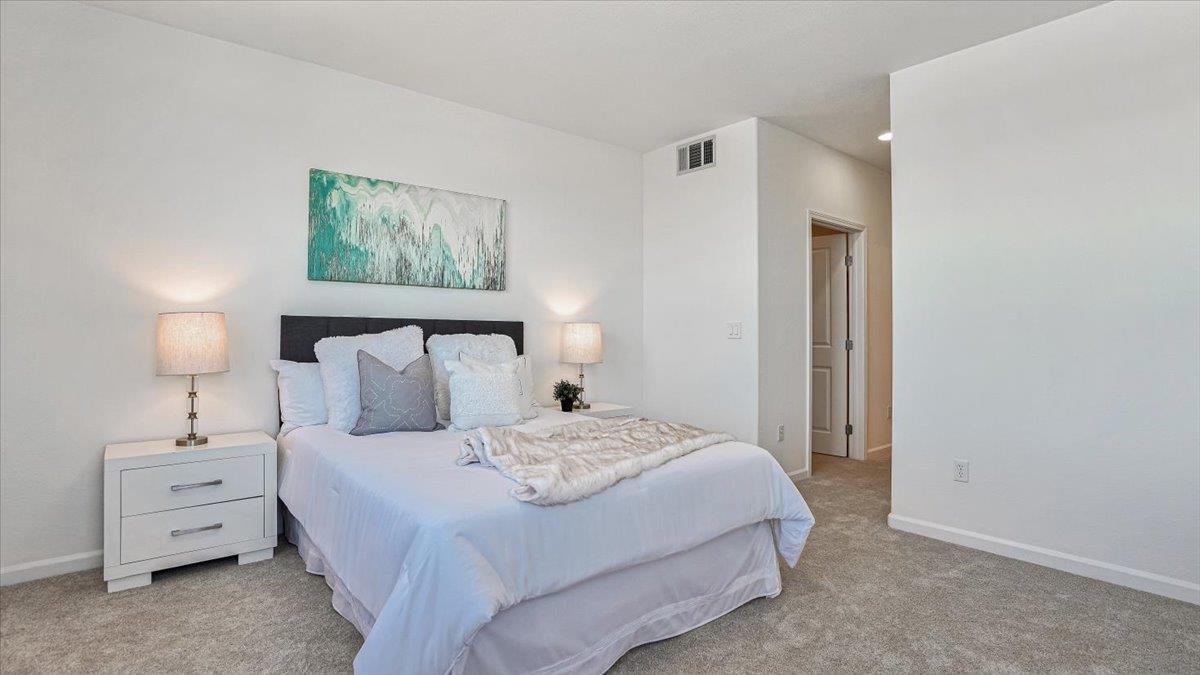 1388 Broadway, Unit 407 Millbrae, CA 94030 - Photo 16 of 28 a bedroom with a bed and a night stand