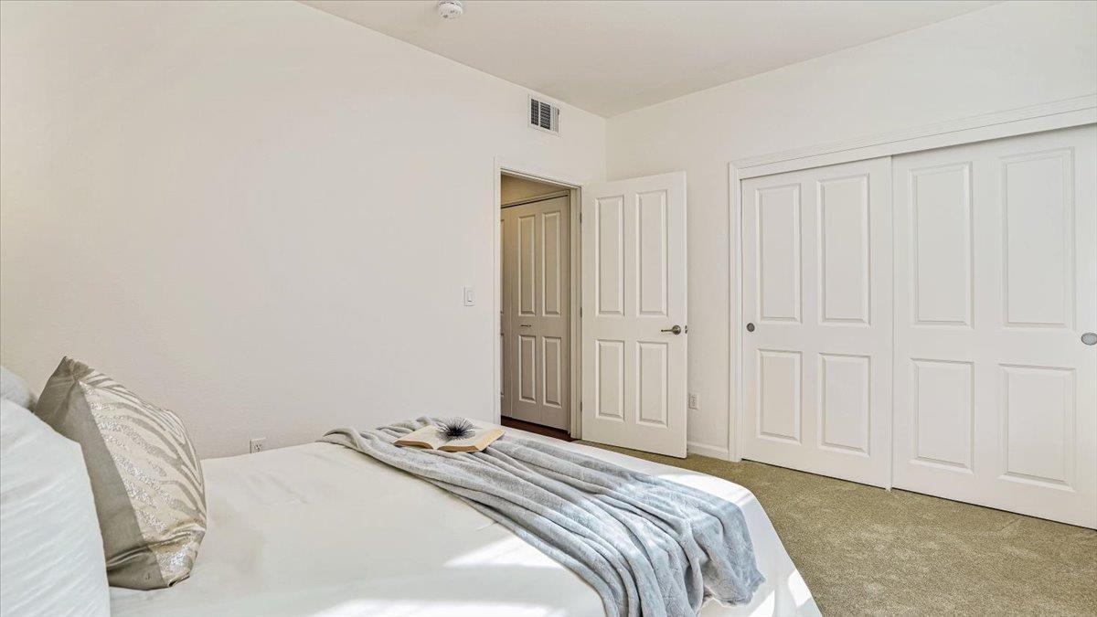 1388 Broadway, Unit 407 Millbrae, CA 94030 - Photo 19 of 28 a bedroom with a bed and a closet