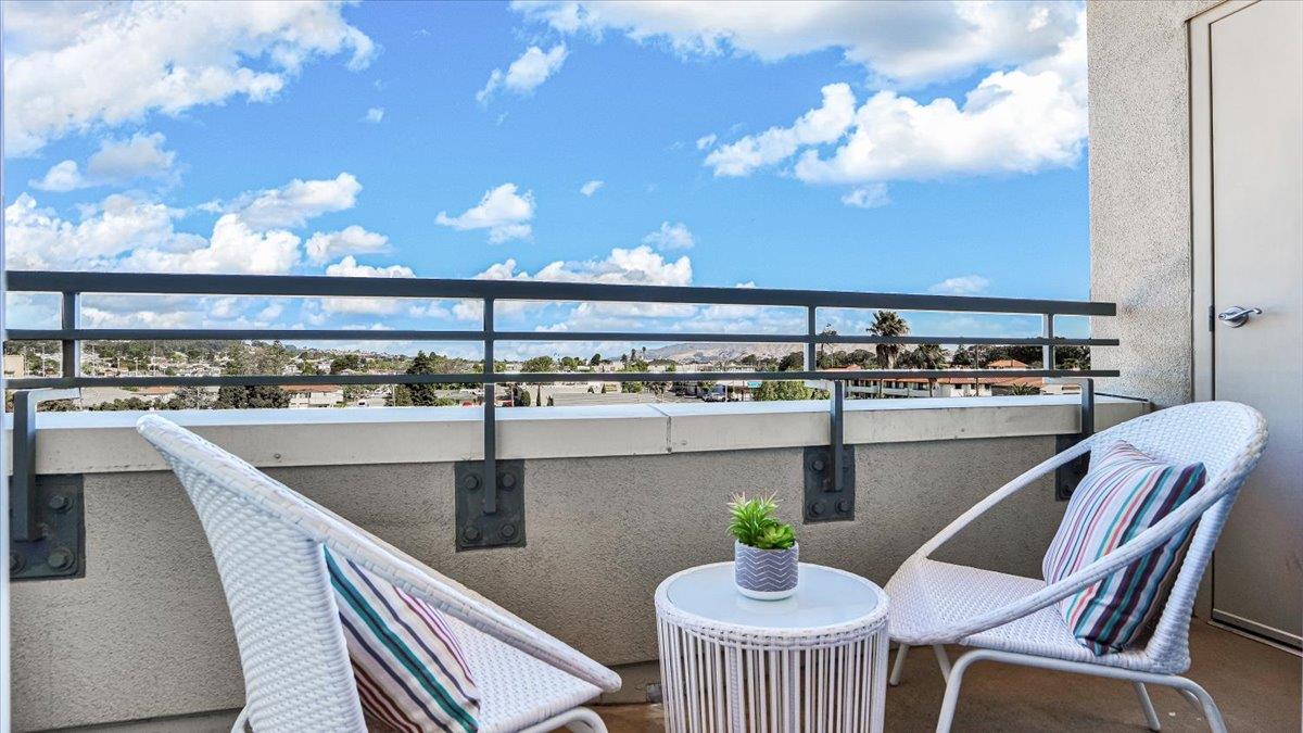 1388 Broadway, Unit 407 Millbrae, CA 94030 - Photo 21 of 28 a kitchen with a table chairs and chandelier