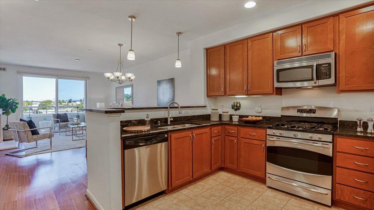 1388 Broadway, Unit 407 Millbrae, CA 94030 - Photo 6 of 28 a kitchen with stainless steel appliances a stove sink and cabinets