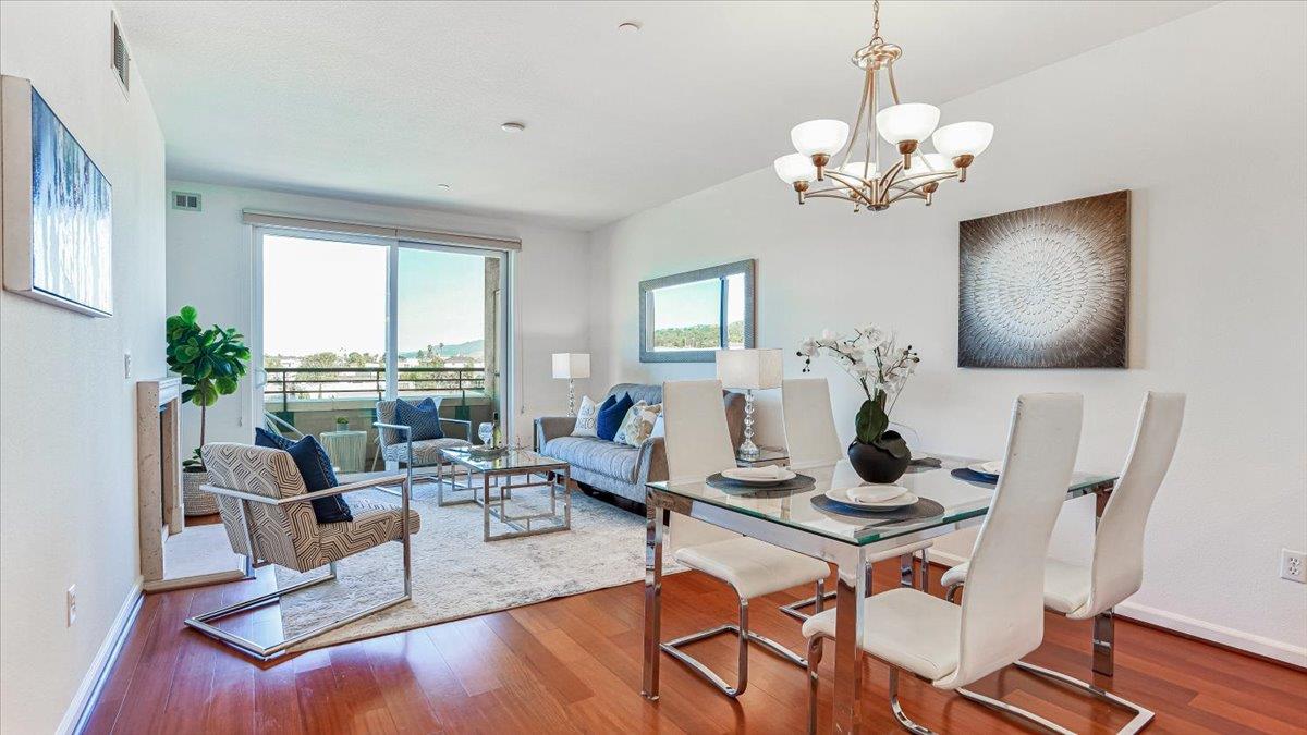 1388 Broadway, Unit 407 Millbrae, CA 94030 - Photo 7 of 28 a living room with furniture a dining table and a chandelier