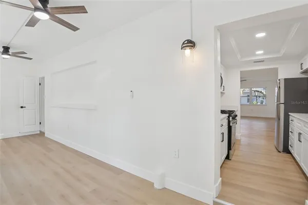 a view of a big room with wooden floor and windows in a room
