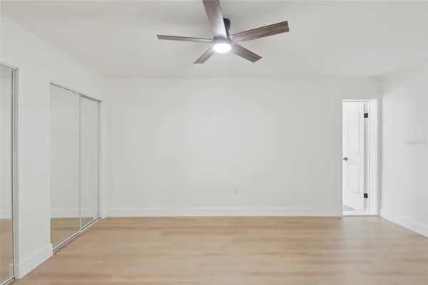 a view of empty room with ceiling fan