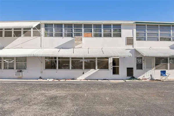 a view of a cars park in front of a house