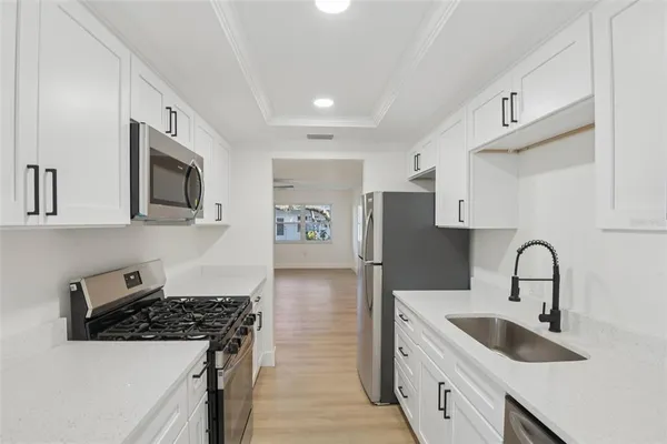 a kitchen with stainless steel appliances a stove a microwave and cabinets