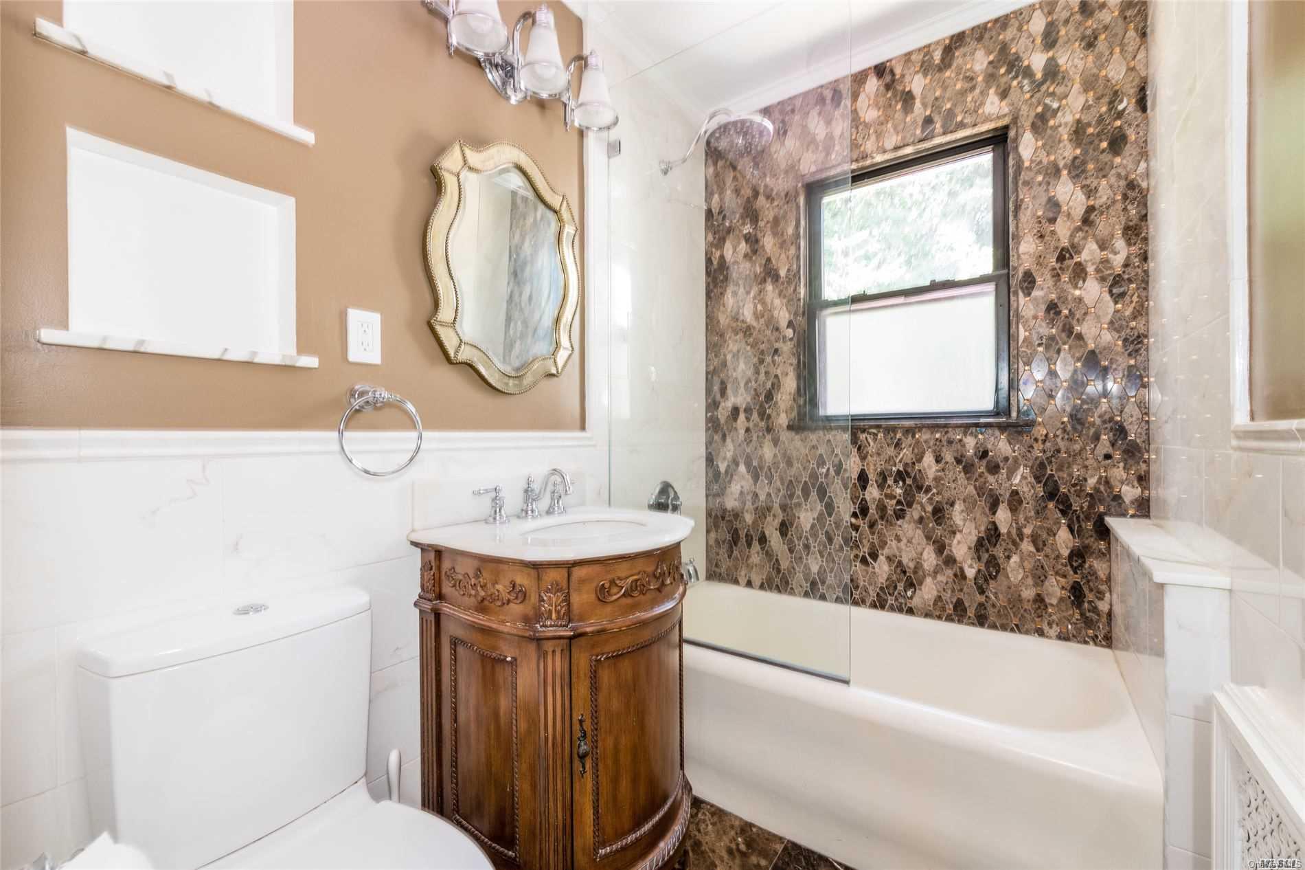85-36 Wareham Place Queens, NY 11432 - Photo 12 of 26 a bathroom with a sink a toilet and a bathtub