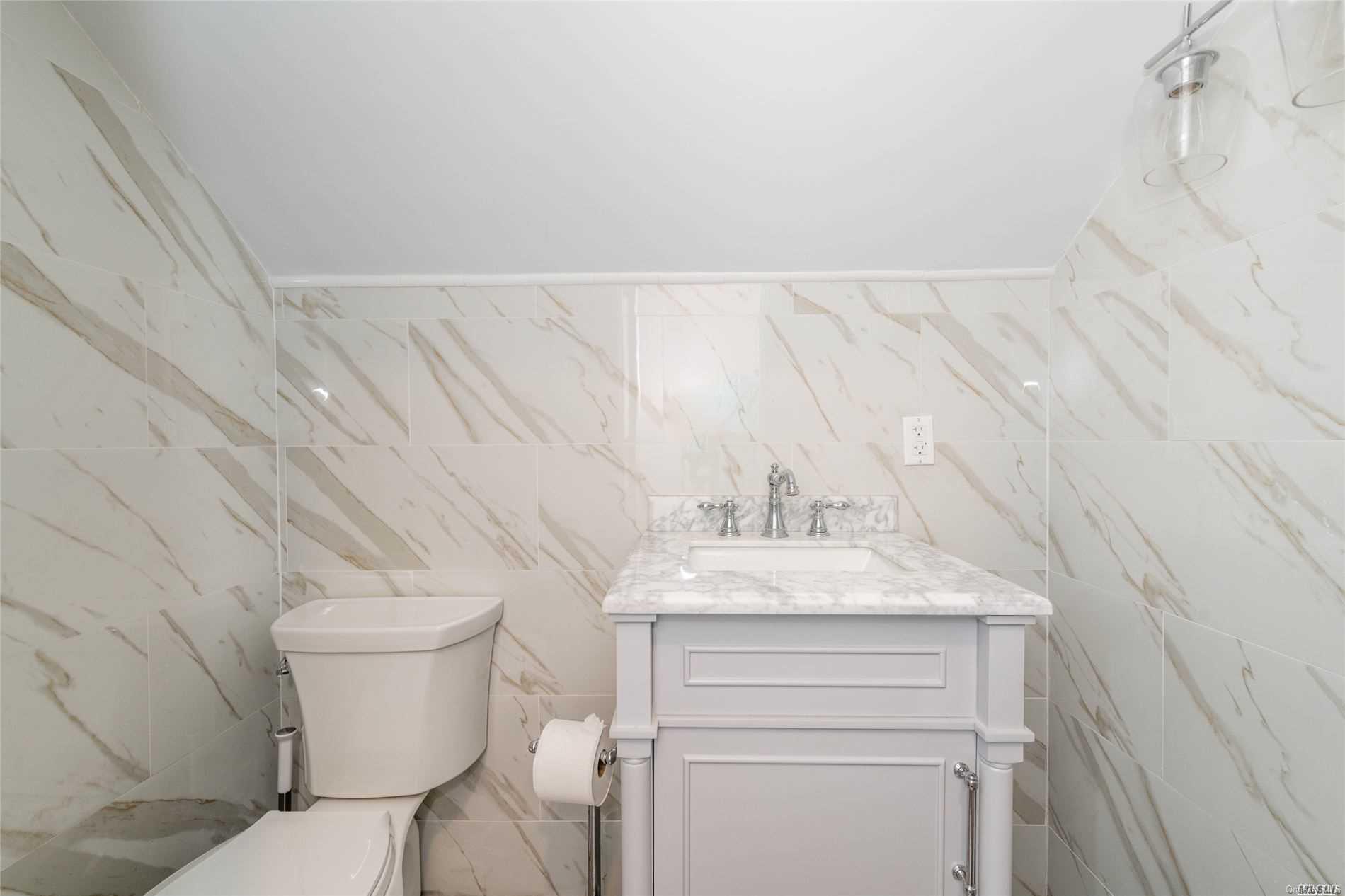 85-36 Wareham Place Queens, NY 11432 - Photo 14 of 26 a bathroom with a granite countertop sink toilet and vanity
