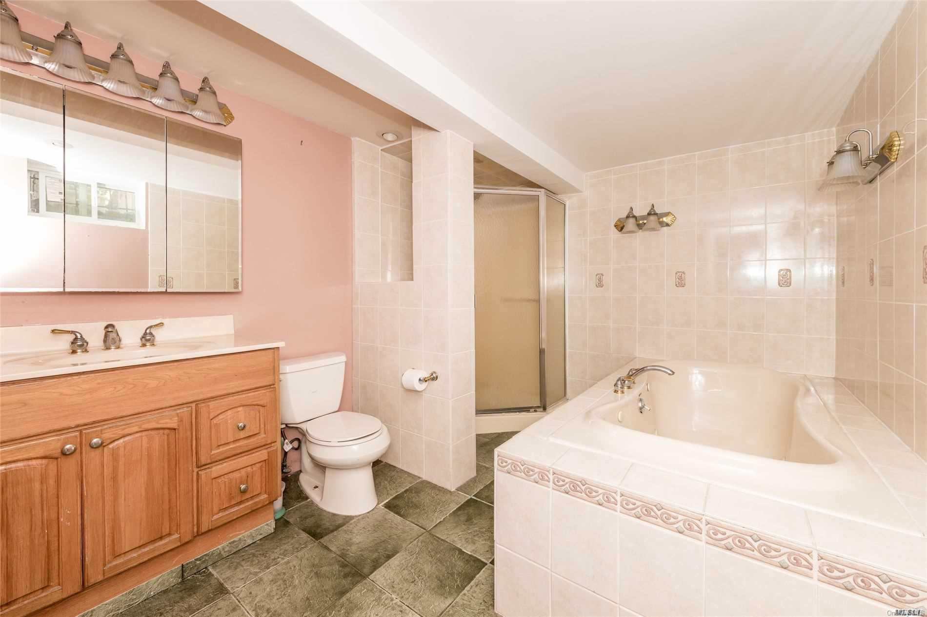 85-36 Wareham Place Queens, NY 11432 - Photo 15 of 26 a bathroom with a sink toilet and shower