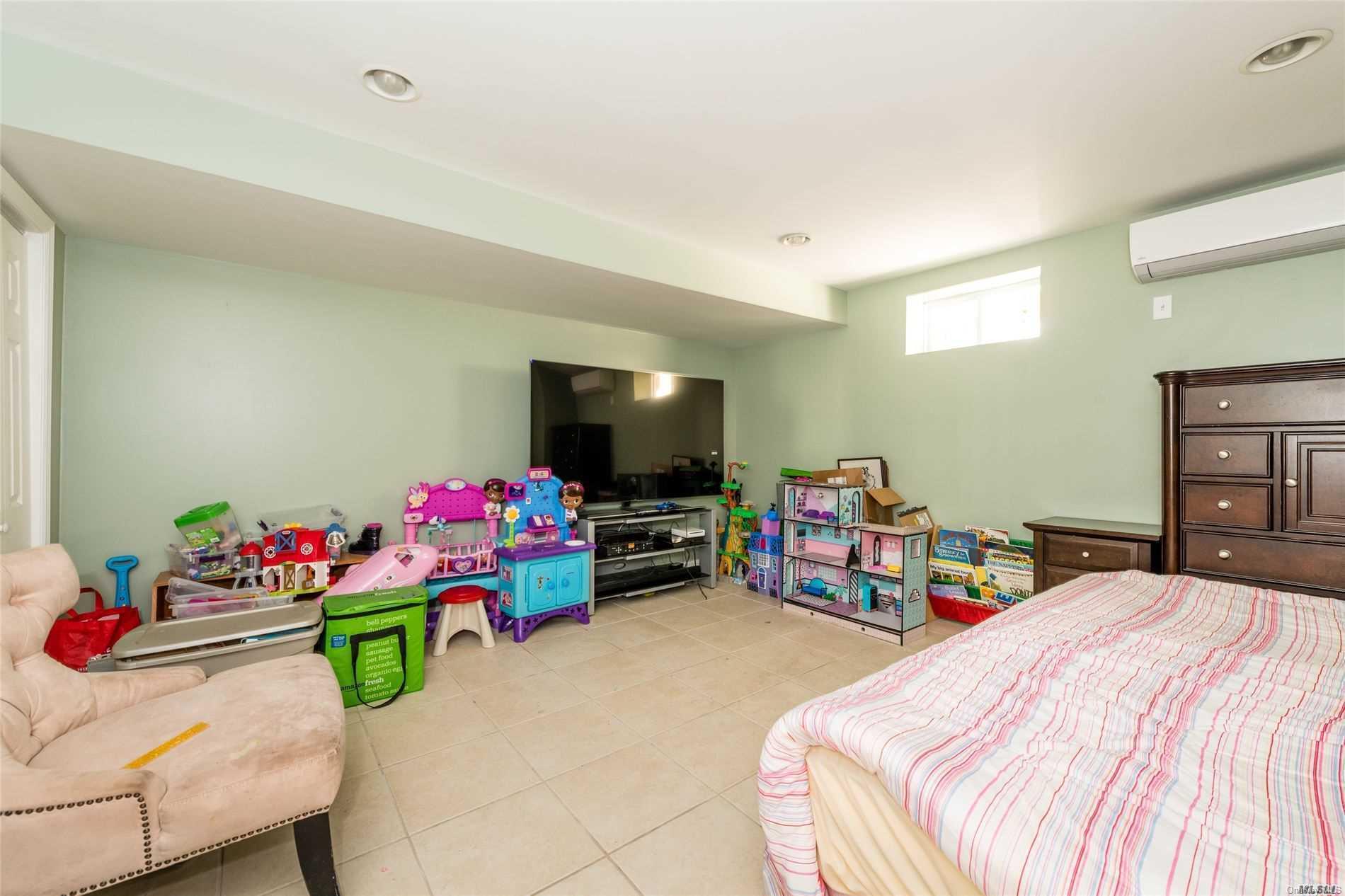 85-36 Wareham Place Queens, NY 11432 - Photo 16 of 26 a bedroom with bed and a flat screen tv