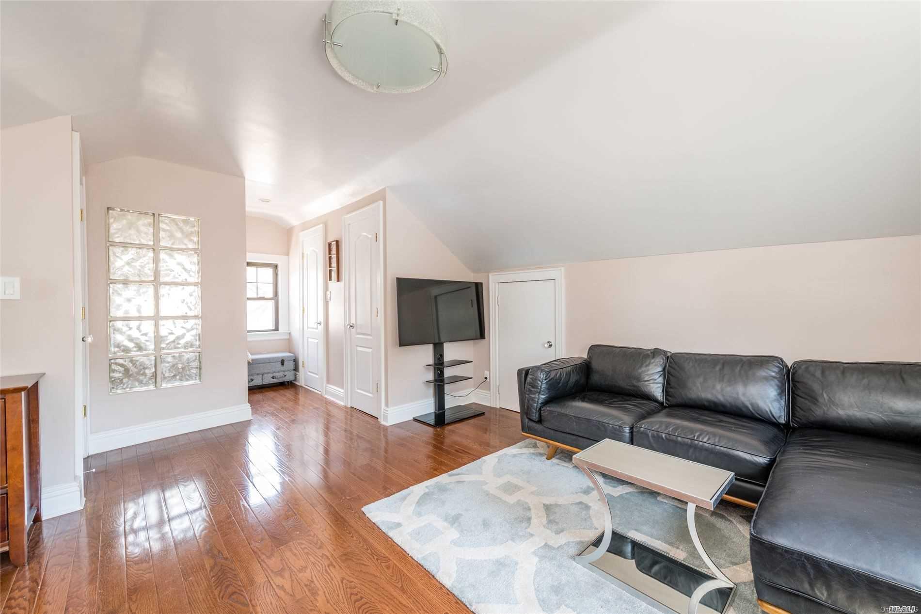 85-36 Wareham Place Queens, NY 11432 - Photo 17 of 26 a living room with furniture and a flat screen tv