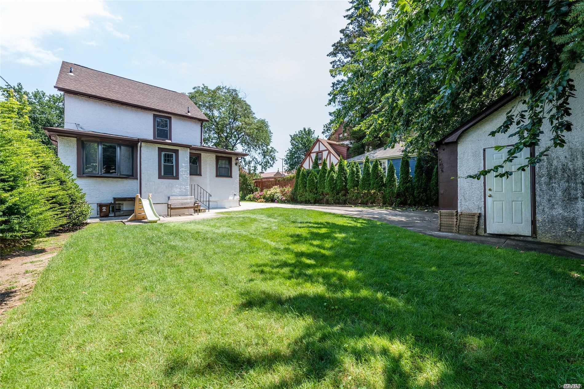 85-36 Wareham Place Queens, NY 11432 - Photo 22 of 26 a front view of a house with garden