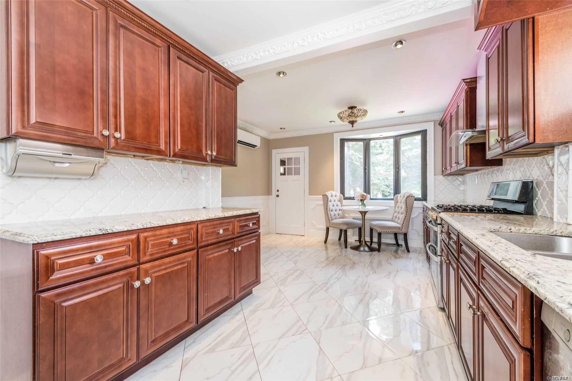 85-36 Wareham Place Queens, NY 11432 - Photo 8 of 26 a kitchen with stainless steel appliances granite countertop a sink dishwasher stove and cabinets with wooden floor