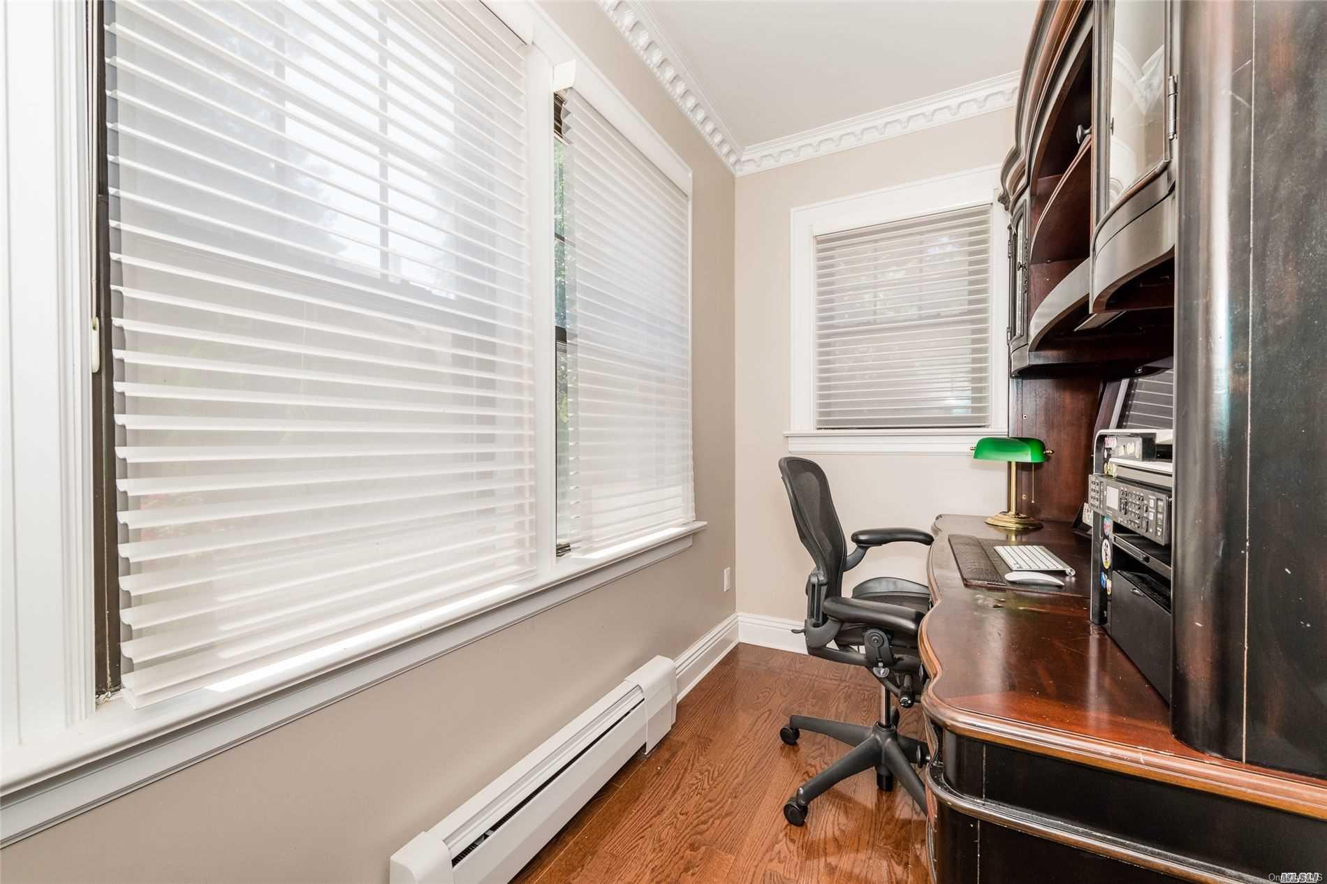 85-36 Wareham Place Queens, NY 11432 - Photo 9 of 26 a view of a workspace with furniture and a window