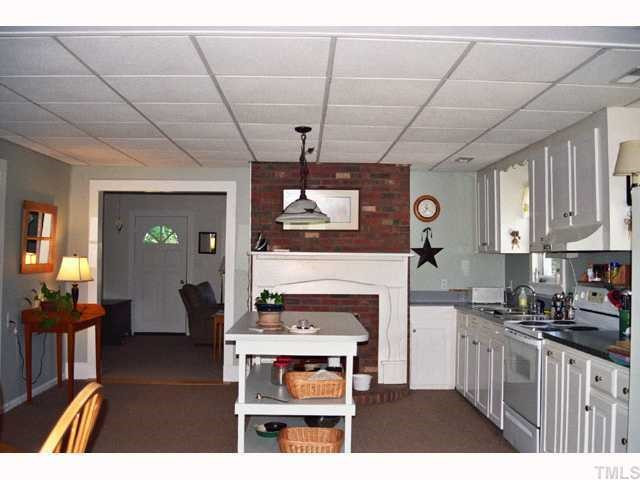 3354 Packing Plant Road Smithfield, NC 27577 - Photo 10 of 12 Kitchen is carpeted and has central island, stove with hood, double sink, and refrigerator. Kitchen