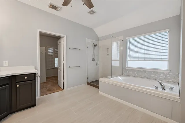 a bathroom with a bathtub and a sink