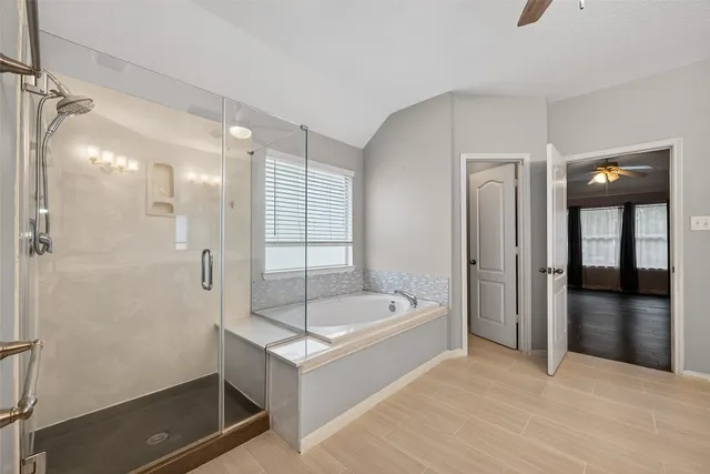 a bathroom with a tub a sink and a shower
