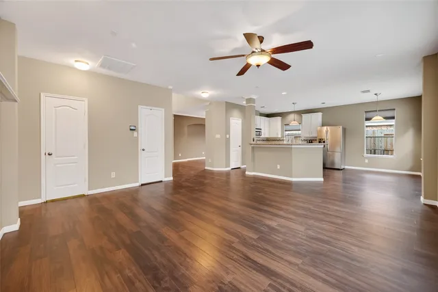 a view of a kitchen with a ceiling fan hardwood floor and a ceiling fan