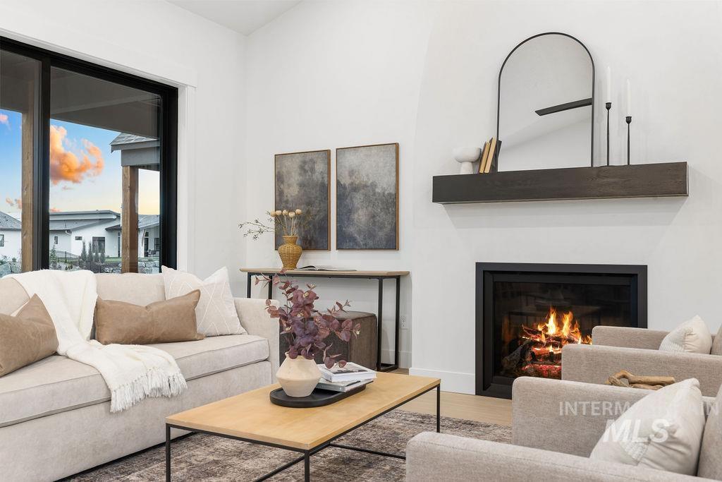 494 Century Avenue Middleton, ID 83644 - Photo 12 of 50 Living area with a lit fireplace and wood finished floors