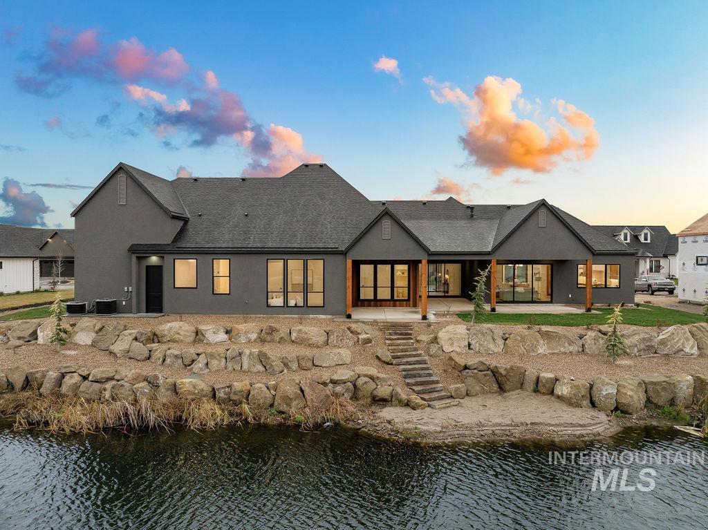 494 Century Avenue Middleton, ID 83644 - Photo 50 of 50 Back of property featuring a patio, a water view, stucco siding, and roof with shingles