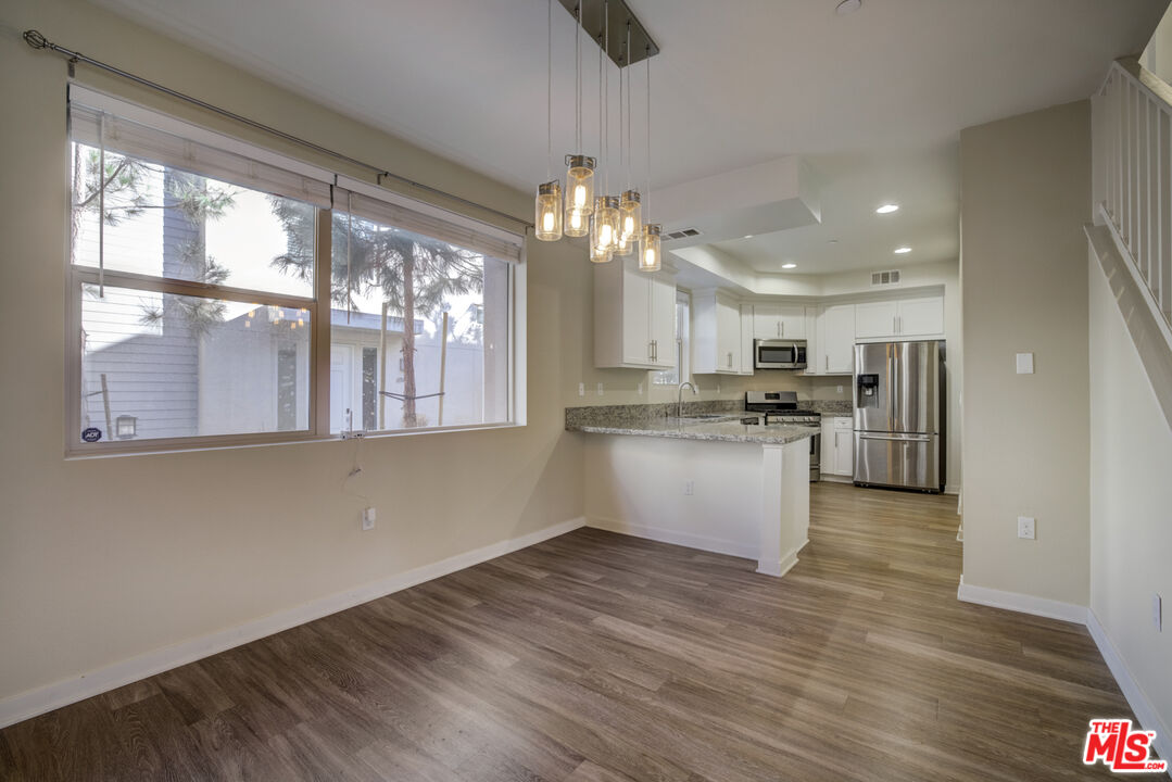694 Colorado Circle Carson, CA 90745 - Photo 13 of 37 a large kitchen with granite countertop a large counter top stainless steel appliances and cabinets