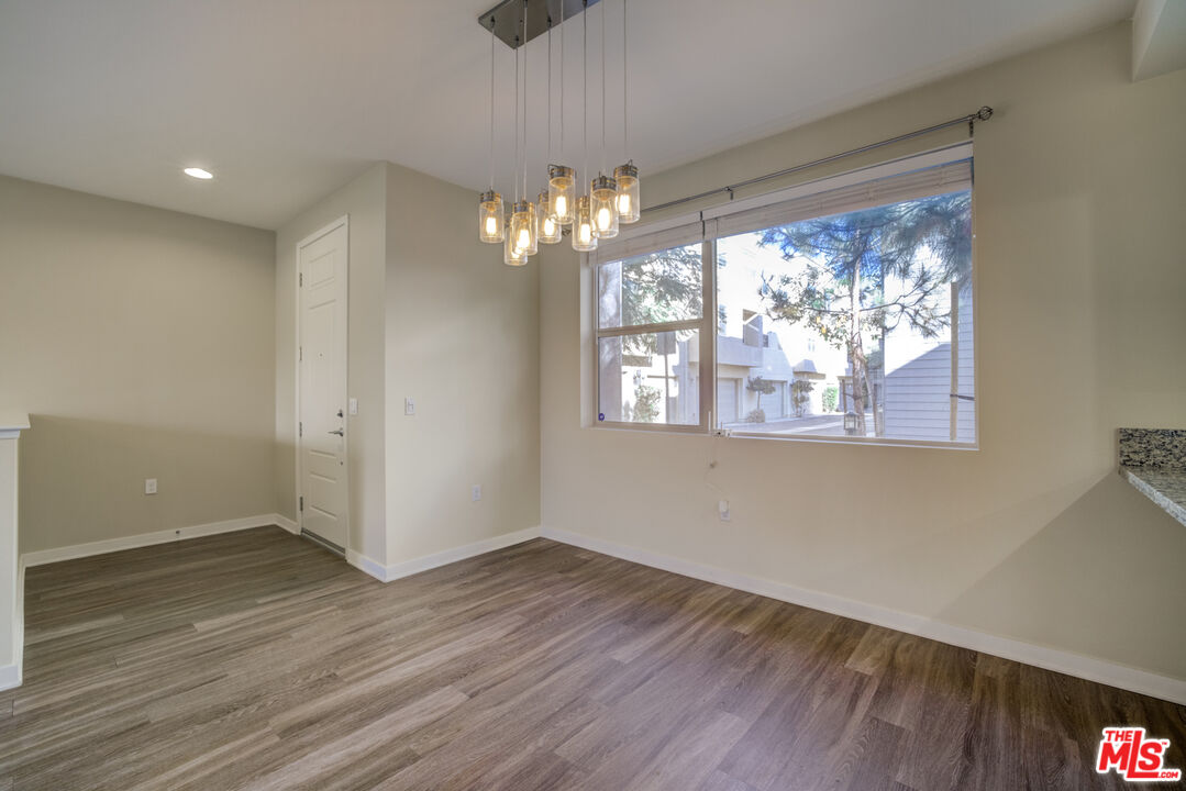 694 Colorado Circle Carson, CA 90745 - Photo 15 of 37 a view of empty room with wooden floor and fan