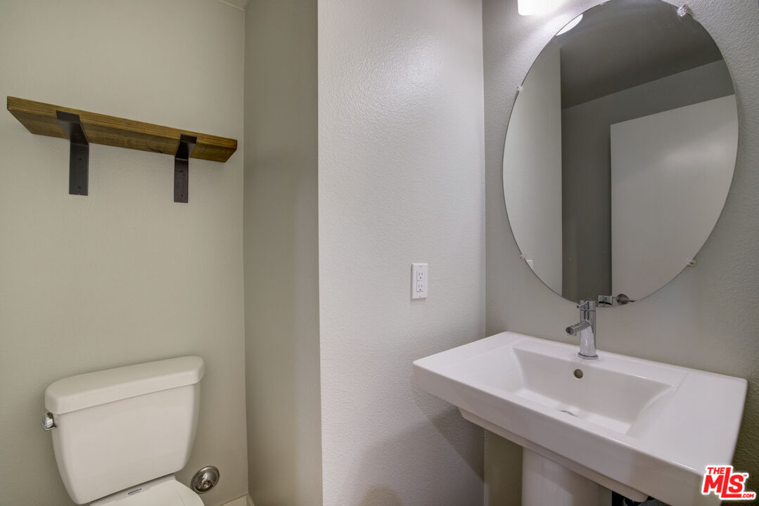 694 Colorado Circle Carson, CA 90745 - Photo 19 of 37 a bathroom with a sink and mirror with toilet