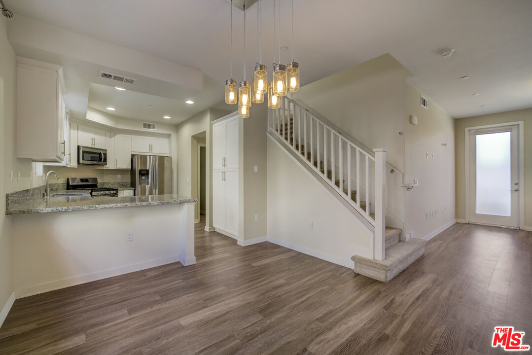 694 Colorado Circle Carson, CA 90745 - Photo 5 of 37 a view of kitchen with cabinets and wooden floor