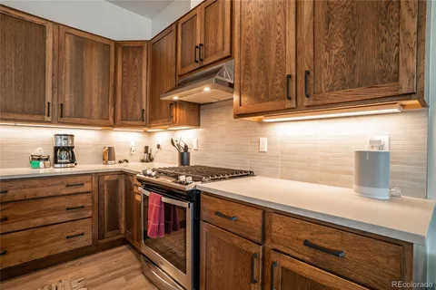 a kitchen with wooden cabinets and a stove top oven