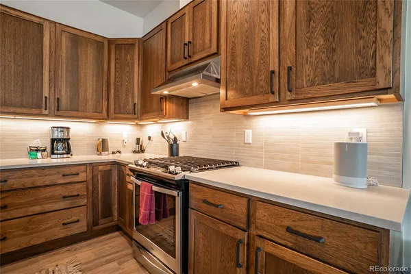 a kitchen with wooden cabinets and a stove top oven