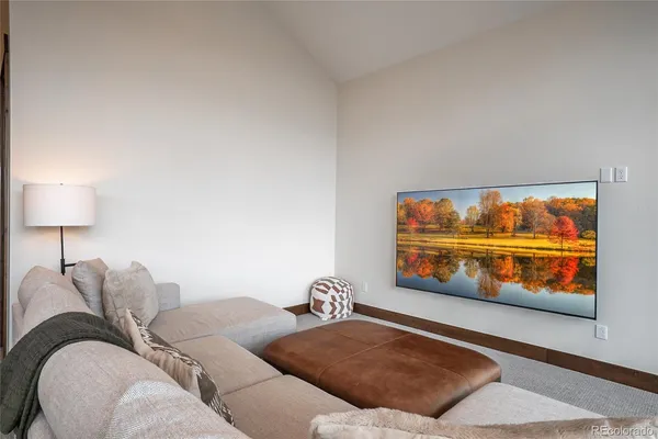 a living room with furniture and a lamp