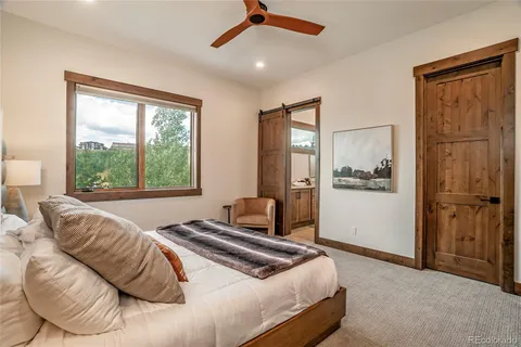 a bedroom with a large bed and a window