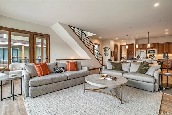 a living room with furniture kitchen view and a table